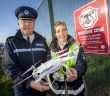 Dublin Airport Chief Police Officer Pat Bracken and Airport Management Unit Operations Officer Nicola Kelly at one of the No Drone Zone signs on Dublin Airport's perimeter fence.