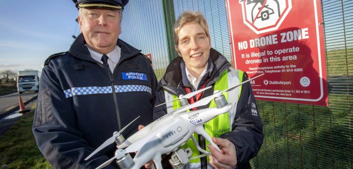 Dublin Airport Chief Police Officer Pat Bracken and Airport Management Unit Operations Officer Nicola Kelly at one of the No Drone Zone signs on Dublin Airport's perimeter fence.