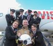 John McCarthy, Station Officer, Airport Fire Service gets a big hug from crew members Corine Schappler and Jessica Wege as captain and first officers look on in the background. Andreas Triska; R Sutter (Capt); F Noel and Mateusz Krakowiak. Pic: Brian Lougheed Photography