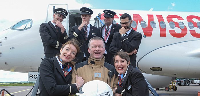 John McCarthy, Station Officer, Airport Fire Service gets a big hug from crew members Corine Schappler and Jessica Wege as captain and first officers look on in the background. Andreas Triska; R Sutter (Capt); F Noel and Mateusz Krakowiak. Pic: Brian Lougheed Photography