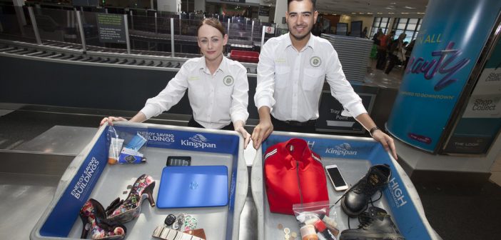 Dublin Airport Security Screening Officers Michelle Halpin and Sergio Rocha with a sample of what passengers should place in the trays at screening