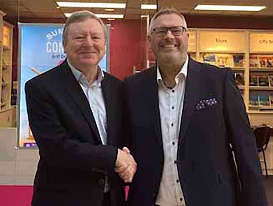 Jeff Collins and Jim Vaughan shake hands on the deal