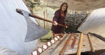 Viking maiden Barbara Power of the Déise medieval history group show off her axe at Winterval Waterford 2025
