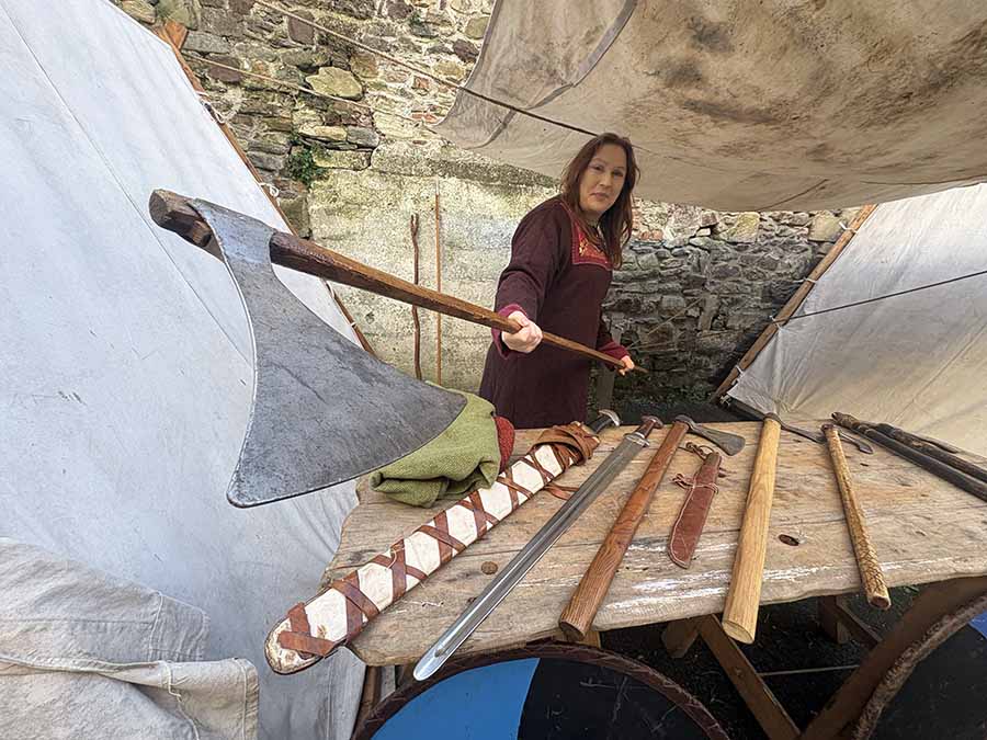 Viking maiden Barbara Power of the Déise medieval history group show off her axe at Winterval Waterford 2025